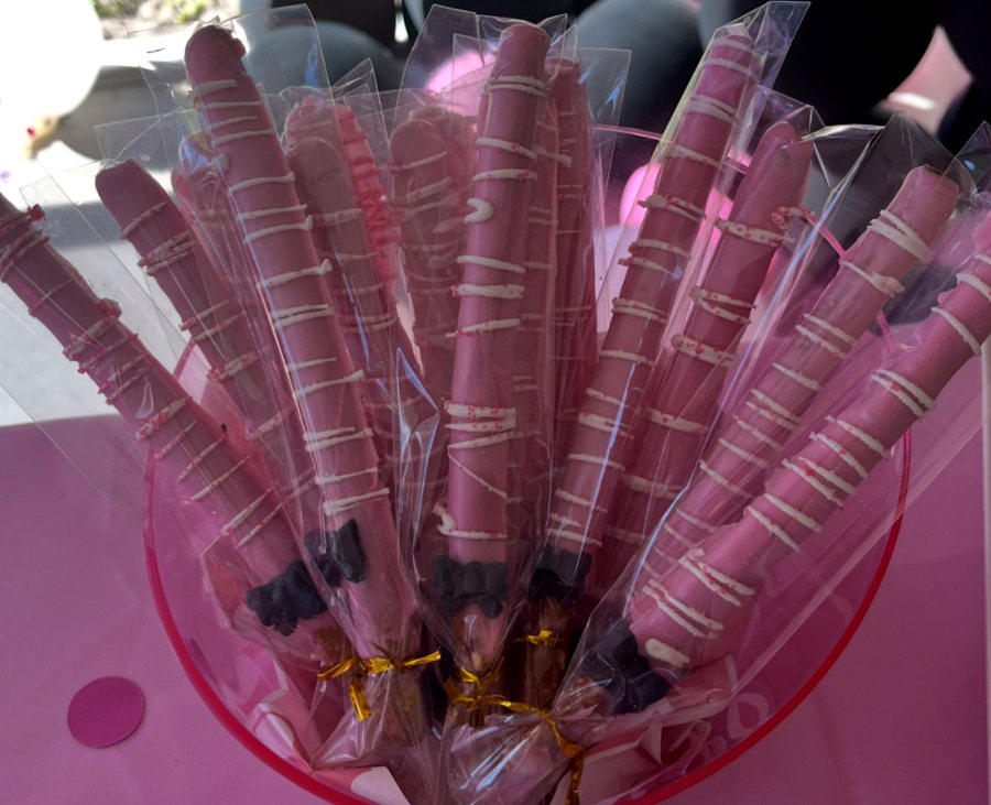 Pink chocolate-dipped pretzel rods with white drizzle